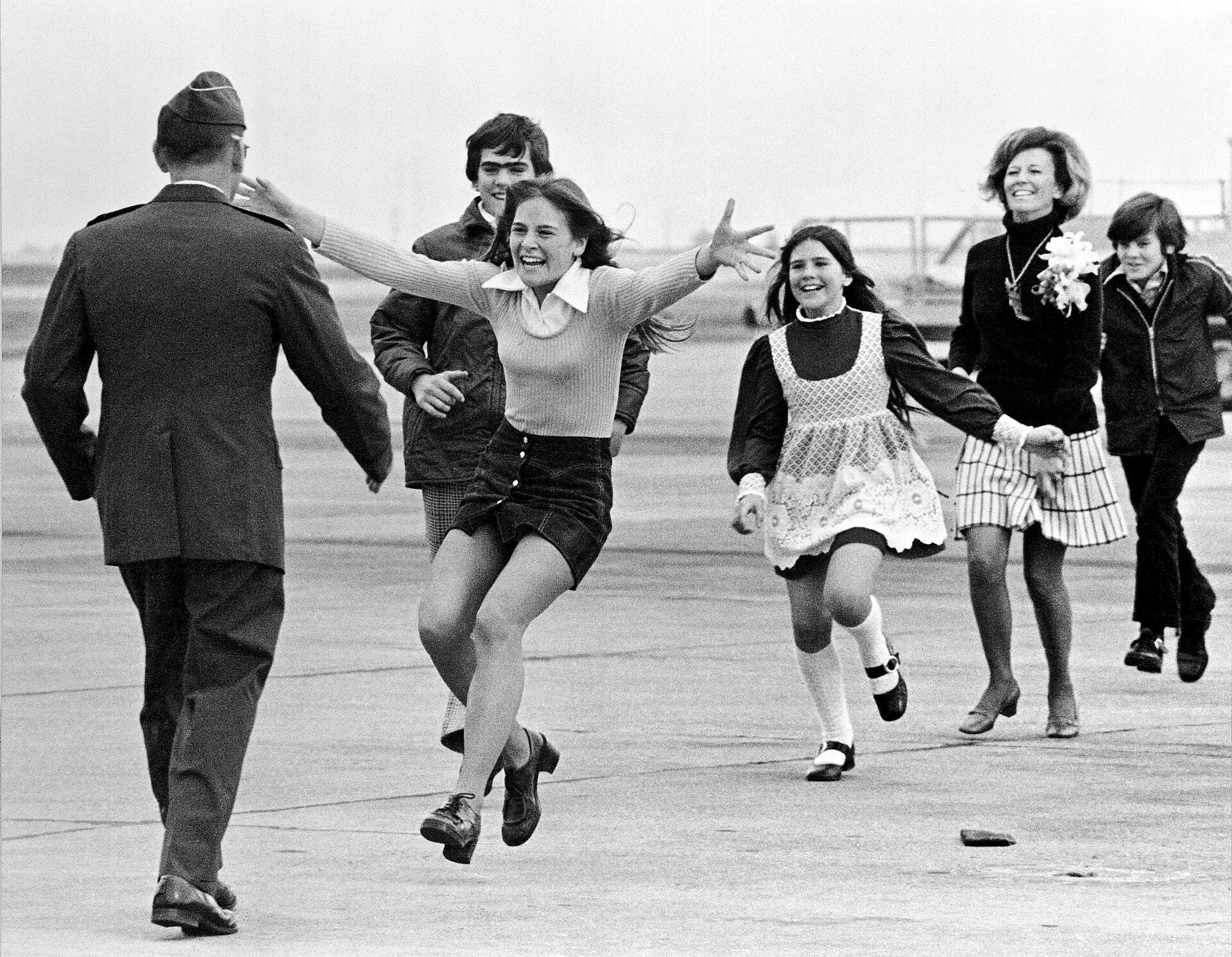 Burst of Joy - A family sprinting toward a returning POW